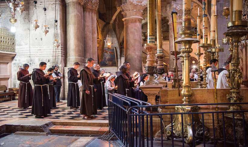a diverse group of people with robes reading from bibles in a religious building a diverse group of people with robes reading from bibles in a religious building