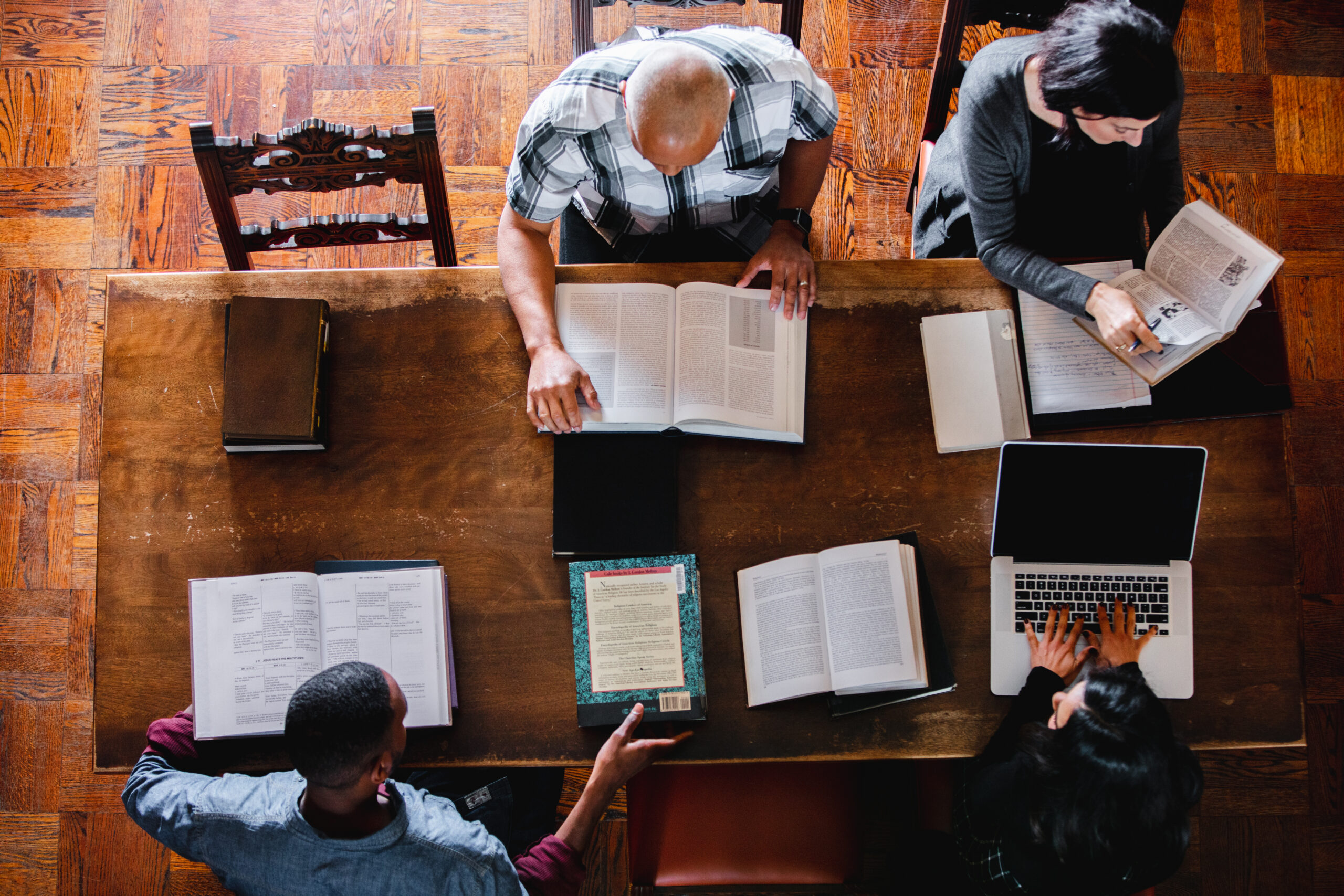 Students in Library with books top down photo