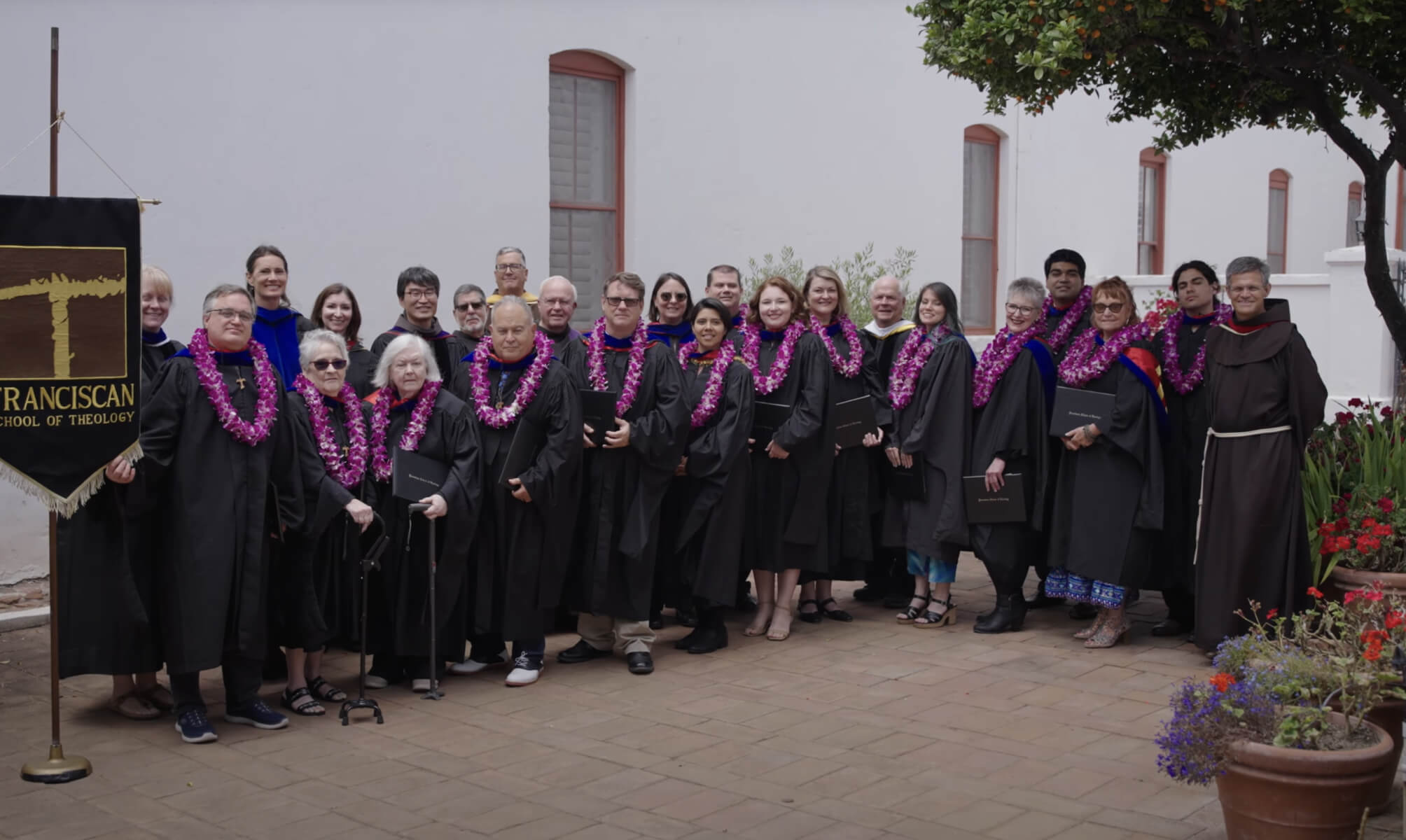 group of fst graduates in their caps and gowns