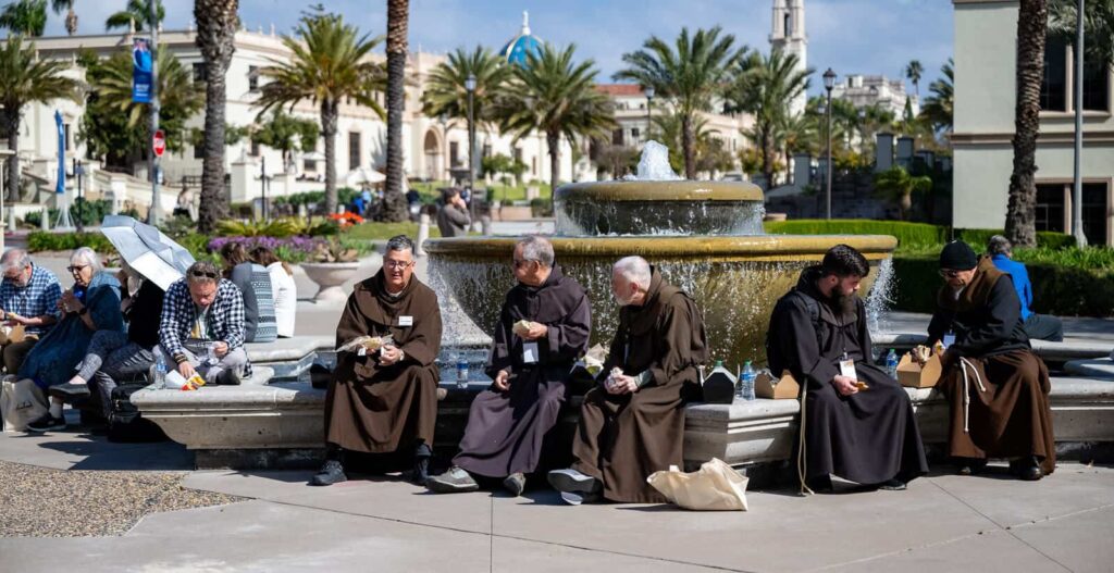 Pope Francis School of Theology and Seminary students enjoy fellowship outside on a bright day.